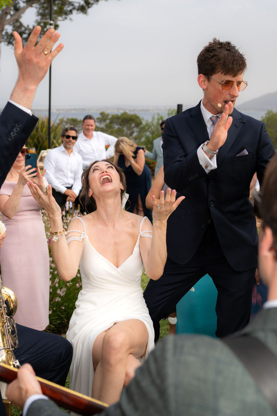 Bride laughing and celebrating with guests during festival wedding Mallorca