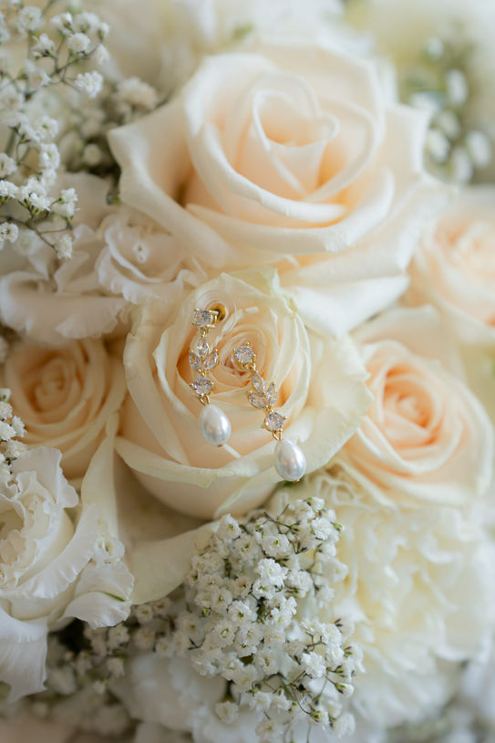 Wedding earrings styled with white roses during Lake Como wedding