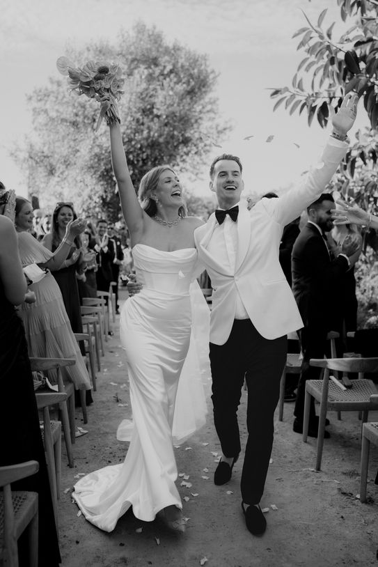 Black and white portrait of bride and groom celebrating in Mallorca.