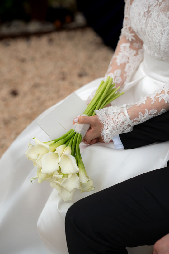 Bride holding bouquet while wearing Rosa Clará wedding dress in Mallorca.