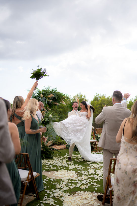 Bride and groom celebrating after Ibiza wedding ceremony.