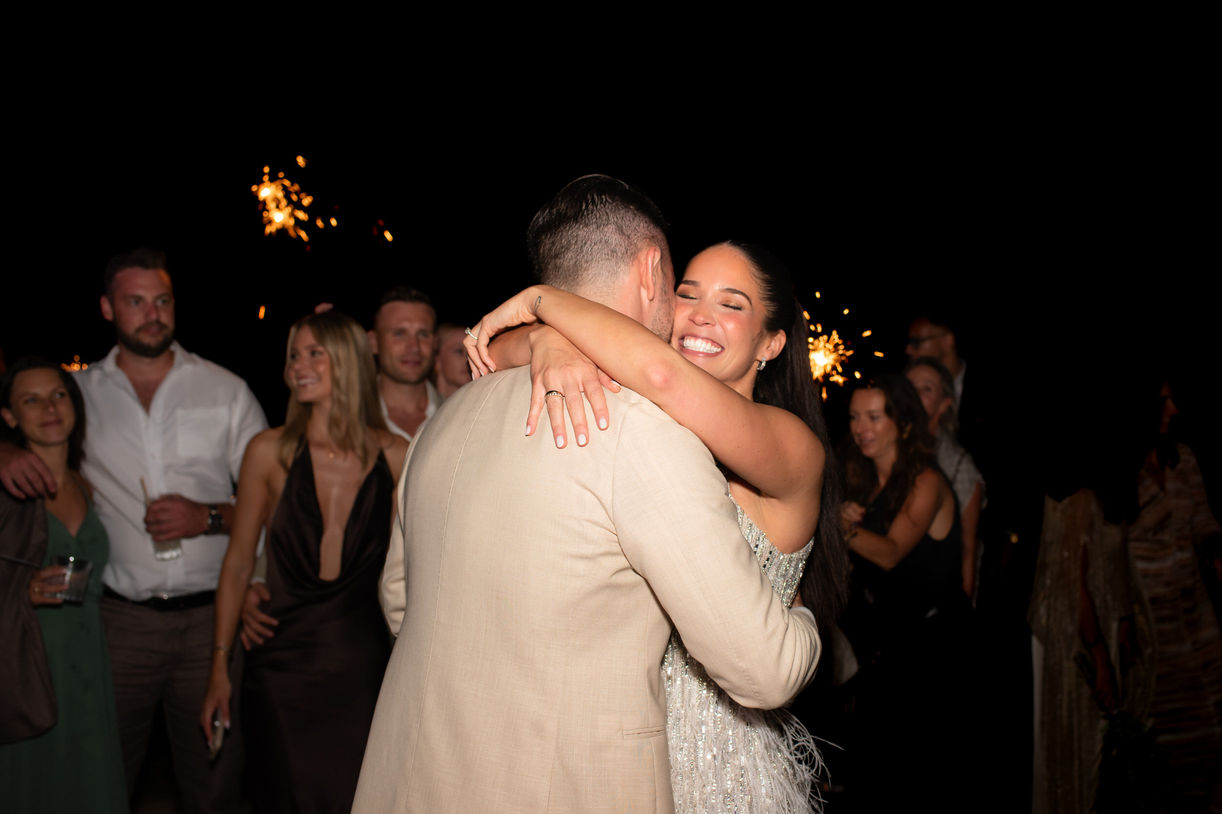 Bride hugging groom during Ibiza wedding party.