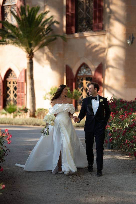 Bride and groom walking together at Castillo de Bendinat Mallorca.