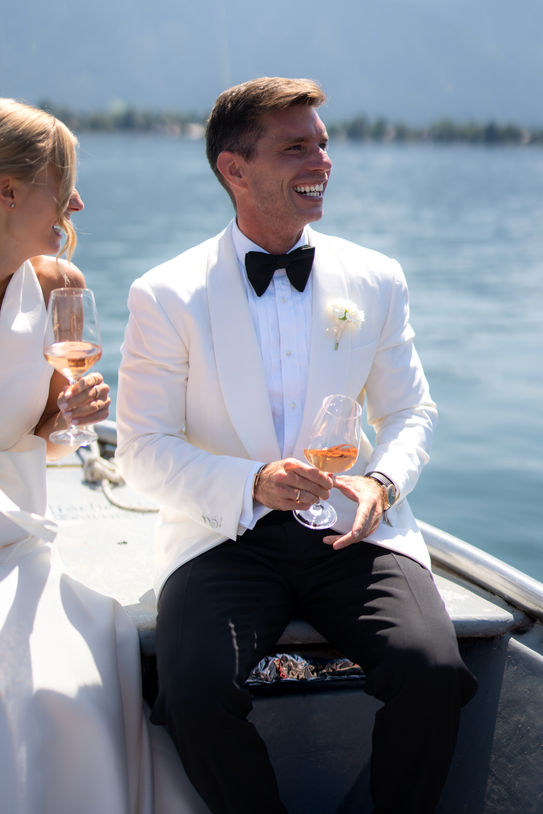 Groom during boat ride at Tegernsee wedding.