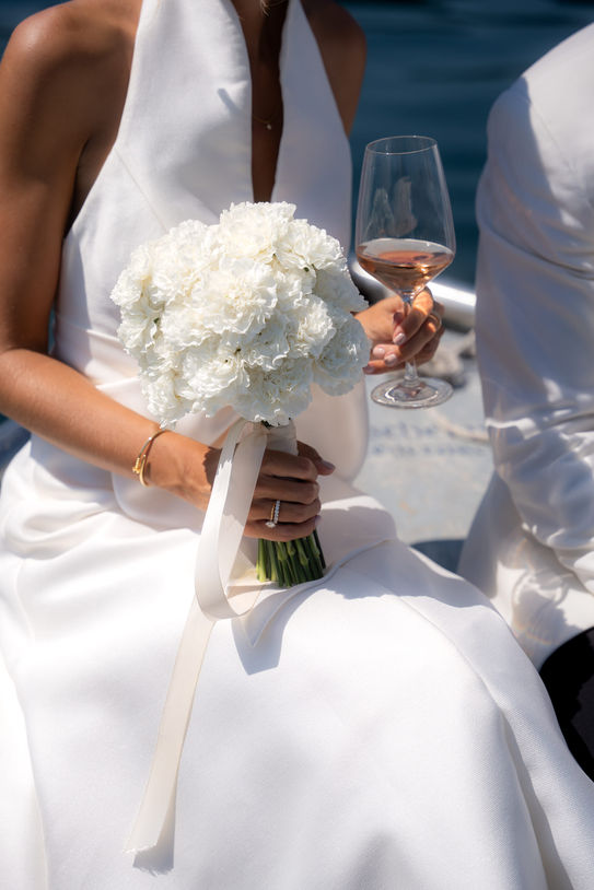 Bride holding bouquet during Tegernsee wedding celebration.