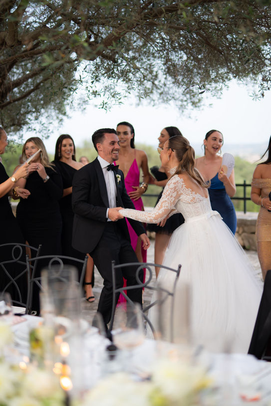 Bride and groom celebrating during an outdoor wedding dinner at Finca Serena Mallorca.