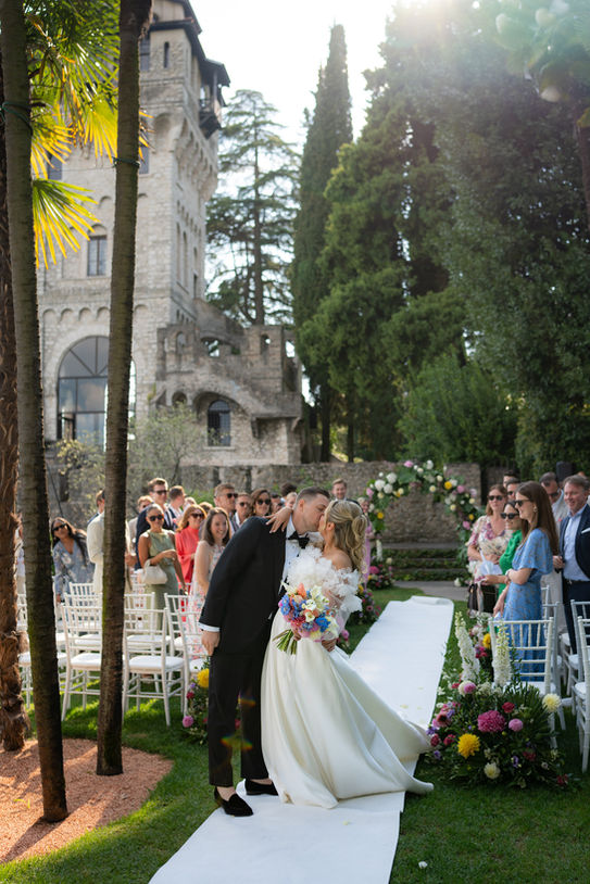 Bride and groom kissing during wedding ceremony at Villa Fiordaliso Lake Garda Italy