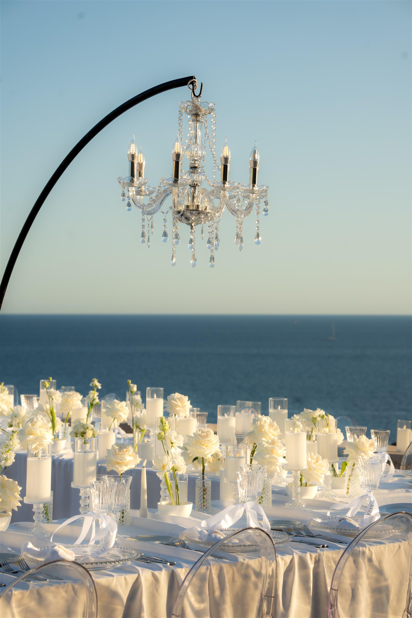 Close-up of wedding table with candles and chandelier decoration overlooking the sea on top of Fort Lovrijenac