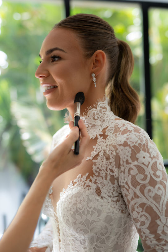 Bride applying makeup before her Mallorca wedding ceremony