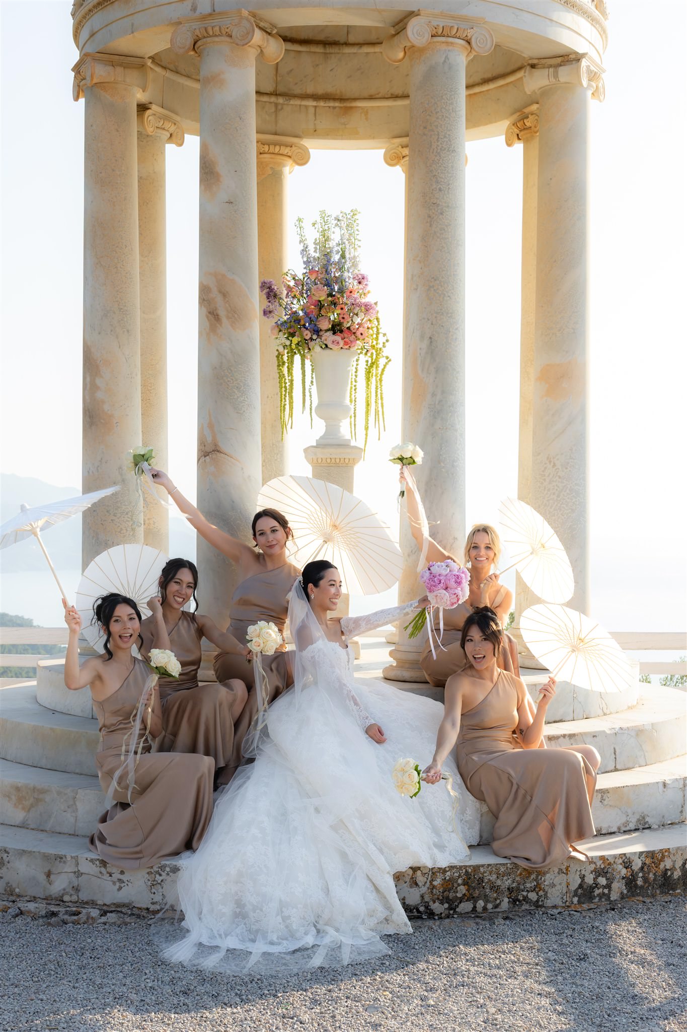 Bride and her bridesmaids in elegant setting of Son Marroig temple, the most iconic sea view venue for destination weddings in Mallorca