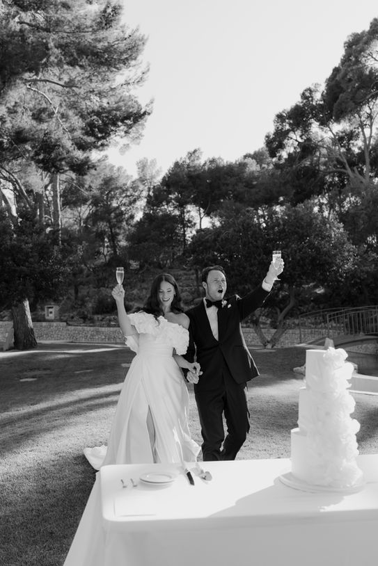 Bride and groom celebrating during cake cutting in Mallorca.