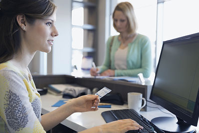 Receptionist taking payment