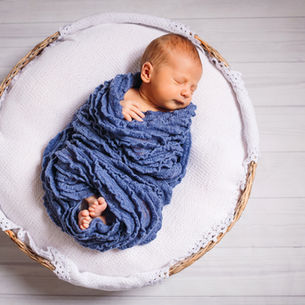 baby wrapped in blue cloth
