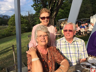 Amelia Johnson and Linda and Lloyd Fish visit while enjoying the barbecue dinner