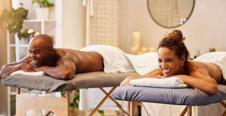 Black couple spa massage and happiness on a table for luxury zen and relax together at a h