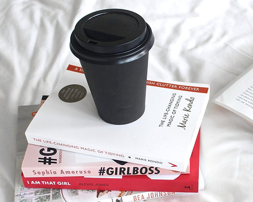 coffee cup on a stack of magazines