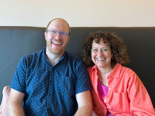 Ameriga Alonzo and Justin Eisinga smiling together during leadership transition.