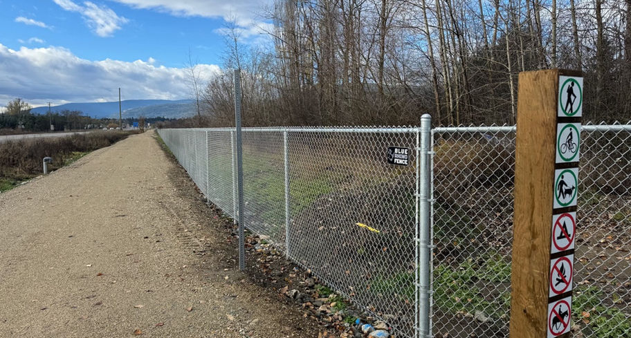 Panoramic view of the industrial chain link fence barrier at the armstrong rail trail