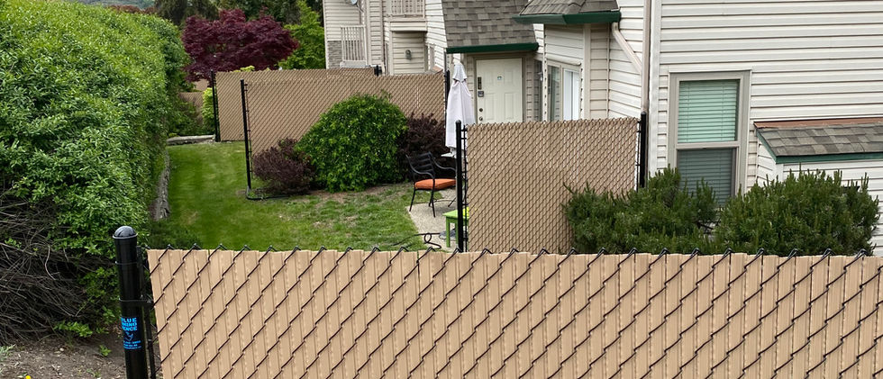 chain link privacy fencing with tan coloured privacy slats at a vernon bc townhouse complex