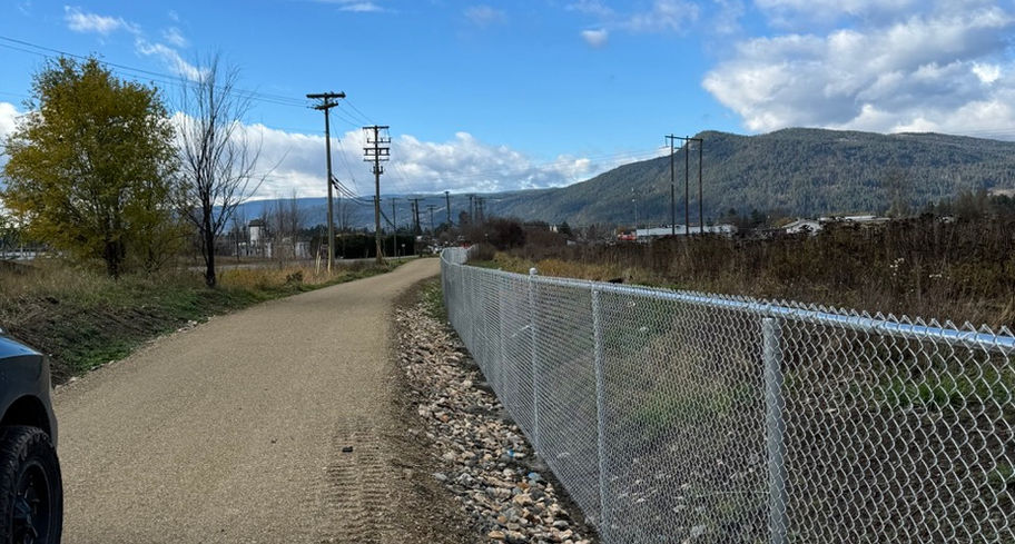 a chainlink barrier erected along okanagan rail trail by blue rhino fence contractor