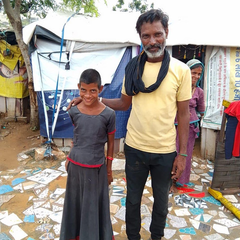 Shy young girl, smiling with her dad, who is also smiling