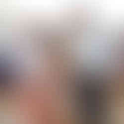 Shy young girl, smiling with her dad, who is also smiling