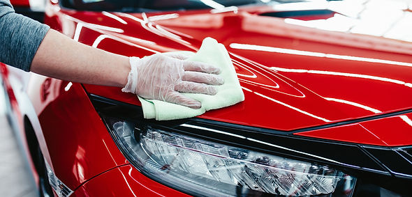 A man cleaning car with cloth