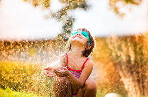 Teenagers playing in the fountain on a hot summer day