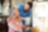 Healthcare, elderly woman with nurse with breakfast at her home and at the table in living