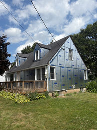 Cape Cod house exterior with silver insulation siding.