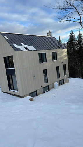 toiture en métal sur maison moderne enneigée