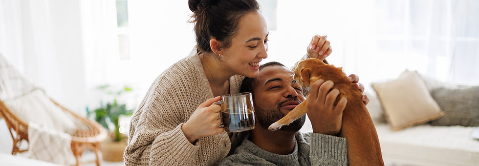 couple with coffee playing with chihuahua dog at home