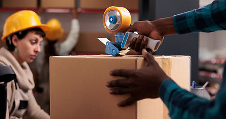 Delivery office manager packing parcel using hand held sticky tape dispenser