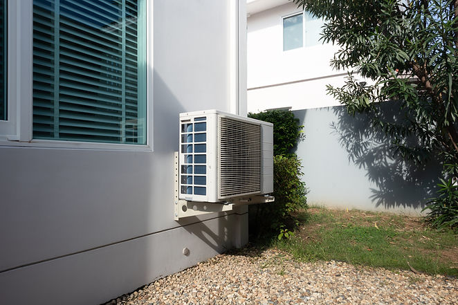 Outdoor air conditioning unit on side of residential house