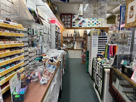Interior view of a craft store with shelves of art supplies