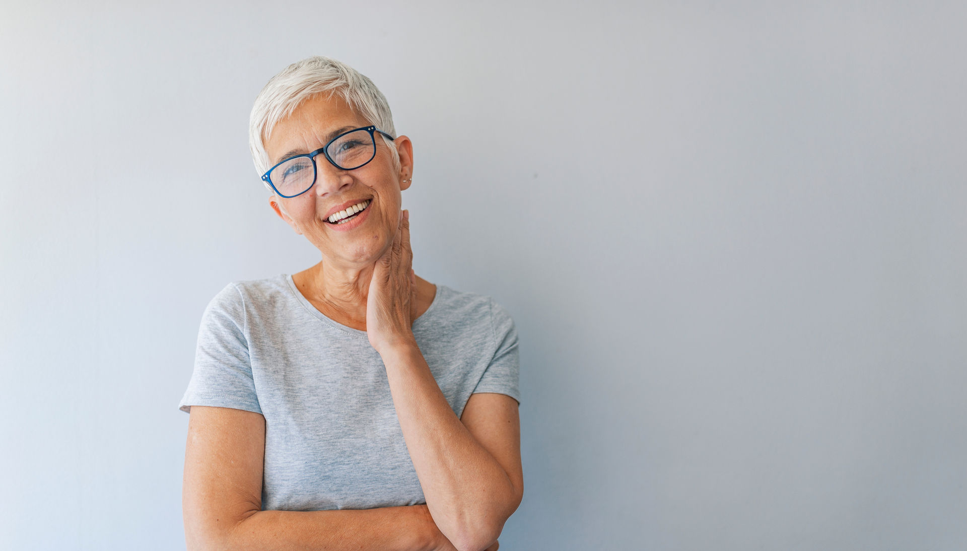 Smiling woman with short grey hair and glasses