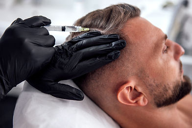 Male undergoing hair restoration treatment