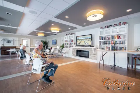 Seniors watching TV game in leisure room, Caudron Place.
