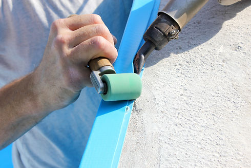 A worker welds plastic cover for water pool. Water pool cover replacement.