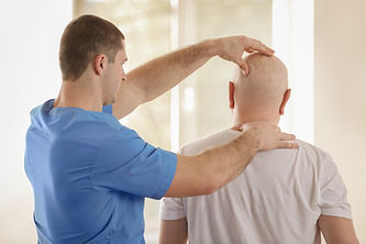 Physiotherapist working with elderly patient in clinic