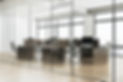 Modern office interior with glass partitions, wooden desks, chairs, and monitors, city sky