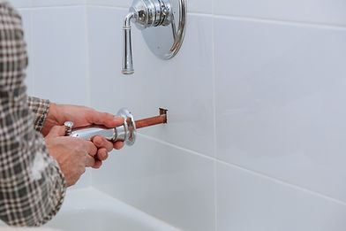Plumber installing a new shower faucet handle