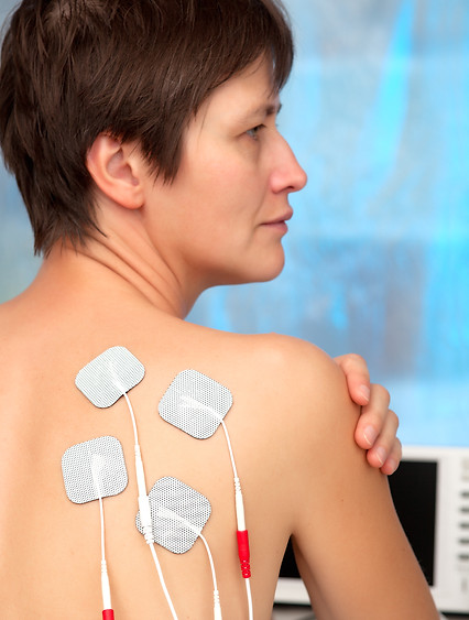 electrodes of tens device on shoulder, tens therapy, nerve stimu