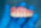 denture in blue hand