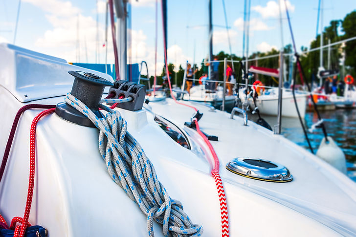 Detail of a sailboat deck with a winch and nylon ropes