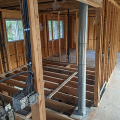 Interior wood framing and electrical wiring for a home renovation.