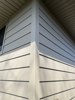 Close-up of light beige horizontal lap siding on a house corner