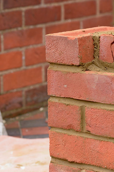 Gate post being built by bricklayer