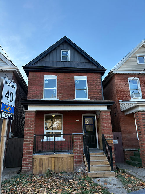 Red brick house with dark grey gable siding and front porch