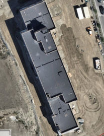 Aerial view of a dark-roofed commercial building